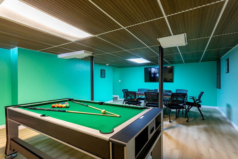 Full game room with pool table, air hockey & separate poker table