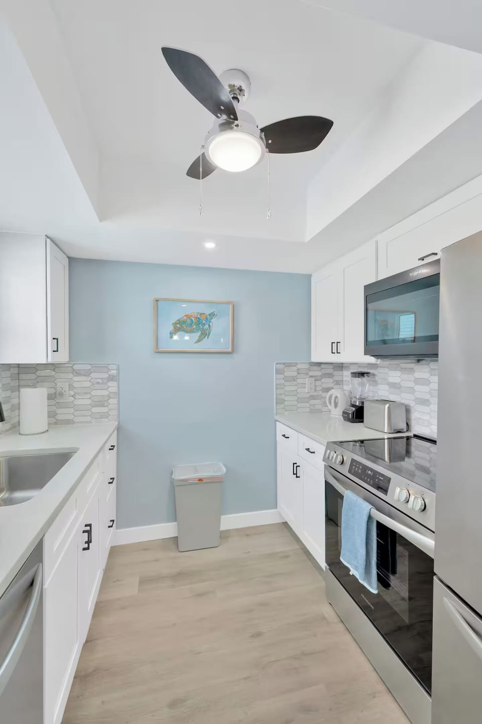 The spacious, fully equipped kitchen features brand-new modern appliances.