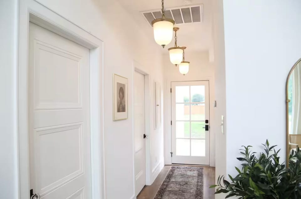 Hallway: A striking path to the laundry and backyard adorned with stunning curated lights and art 