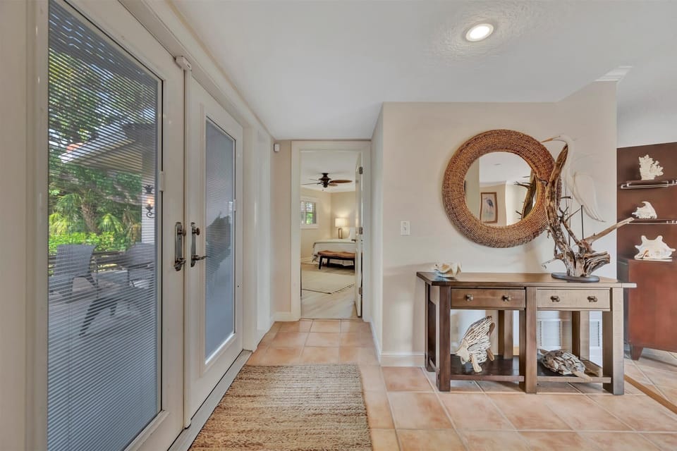 Stylish entry with natural textures leading to a hallway view.
