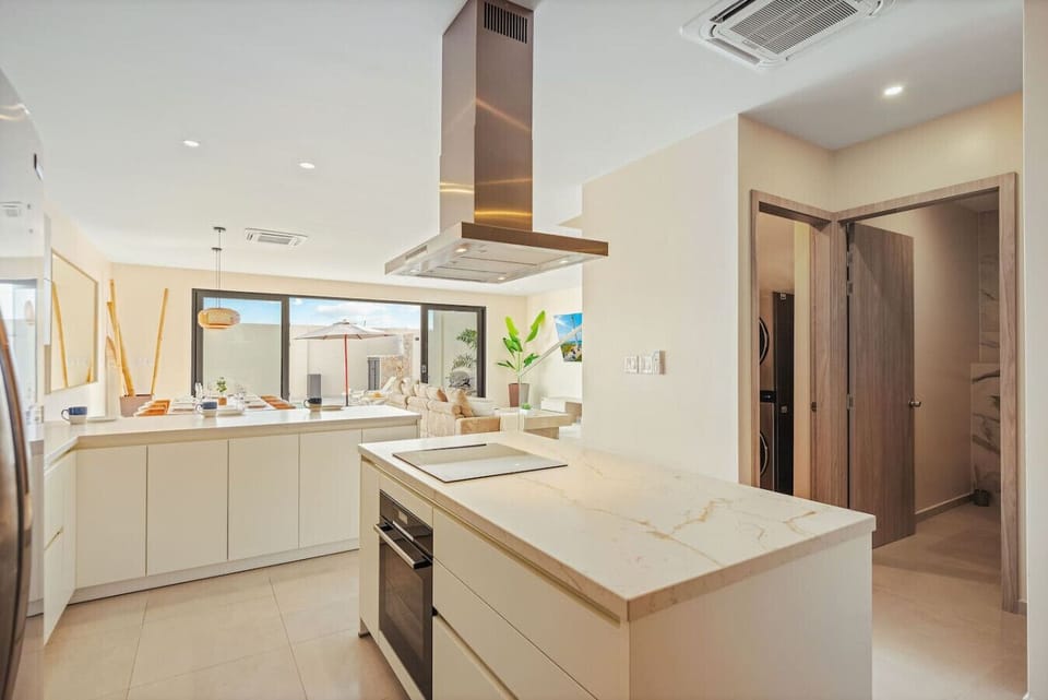 Sleek open kitchen with spacious island, premium appliances, and modern design.