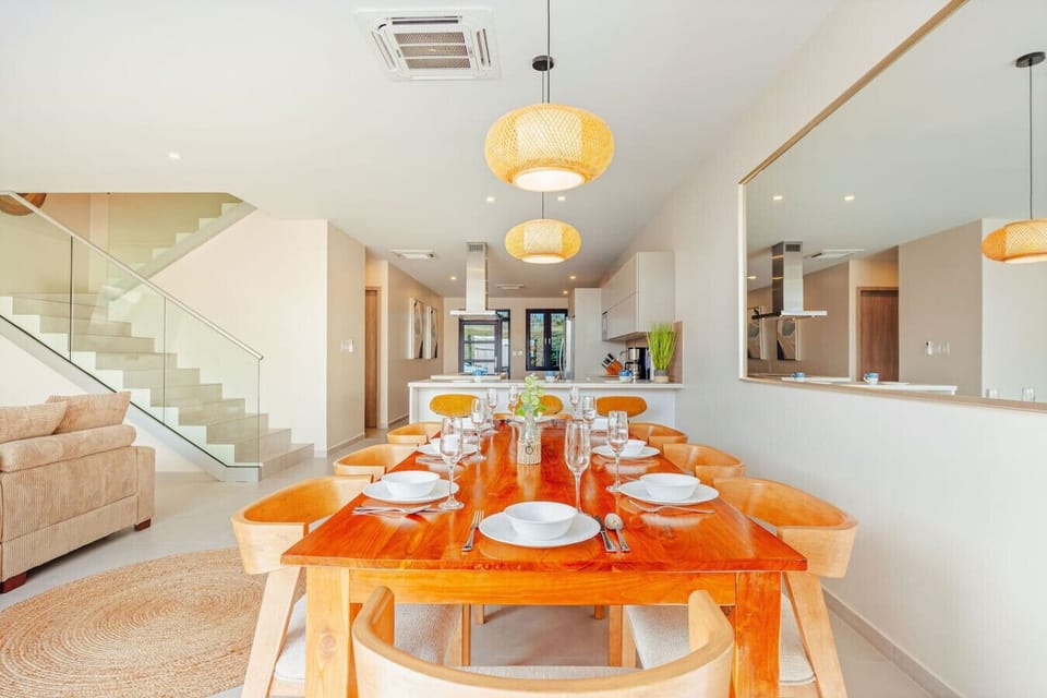 Elegant dining area with crafted wood table and seamless open-plan flow.
