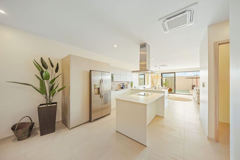 Bright modern kitchen with sleek finishes, spacious island, and open layout.