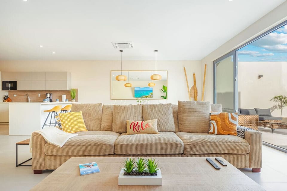 Bright open-concept living space with plush seating and easy pool access.