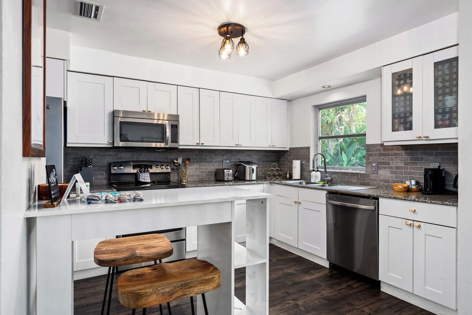Fully equipped kitchen with bar seating and open flow.