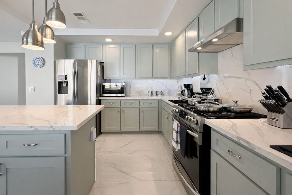 Chef's kitchen featuring dual quartz islands, generous counter space, and etc.