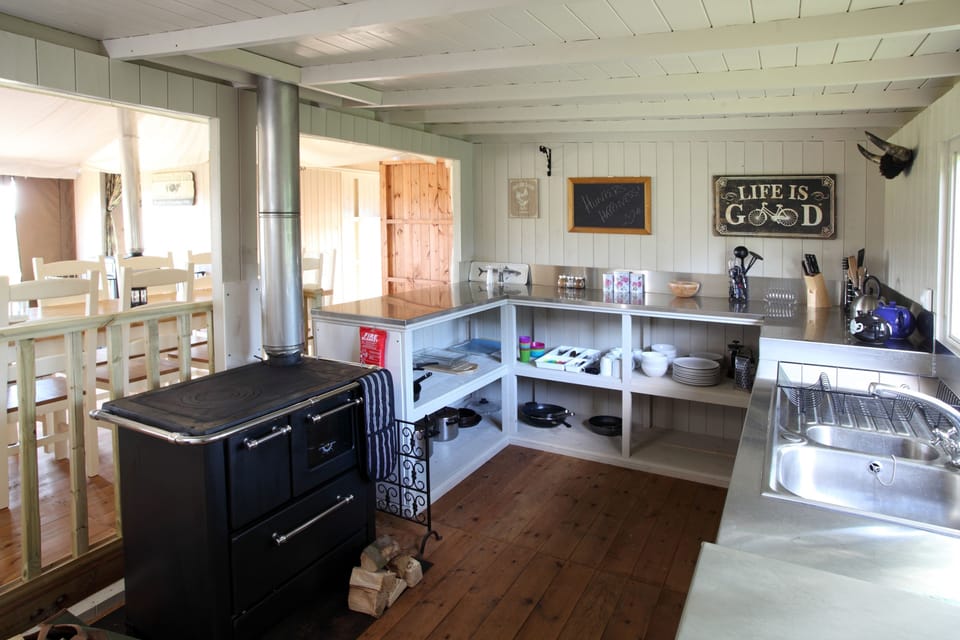 Well equipped kitchen with a wood-stove, unlimited logs and gas hob