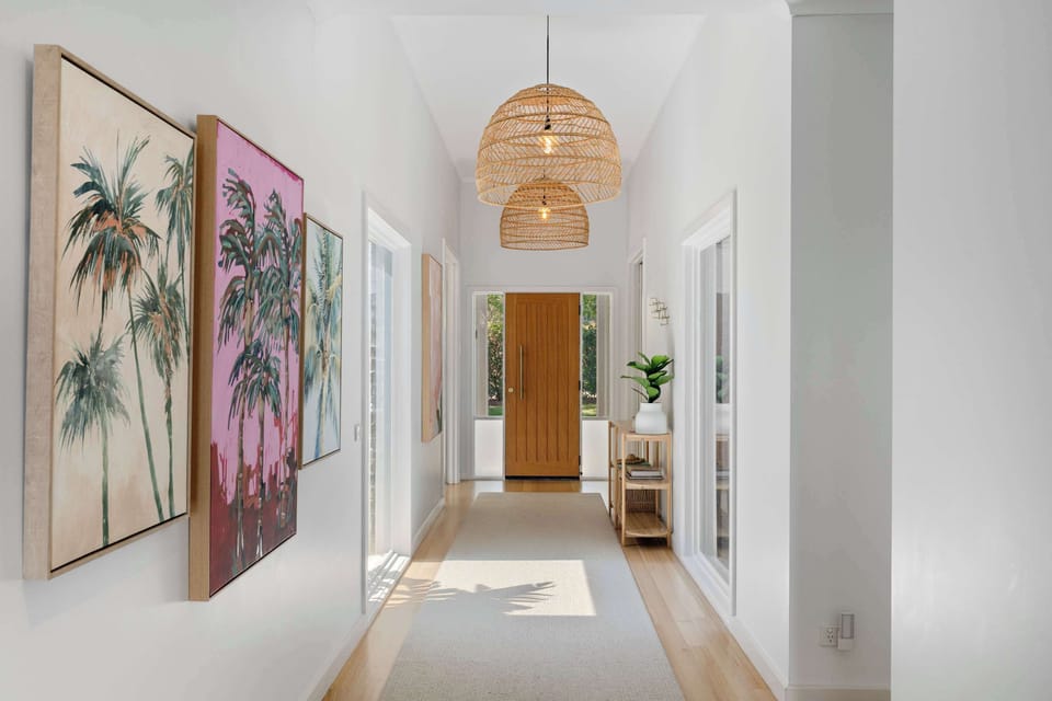 The entry hallway, leads from the front, all the way into the open-living in at the back of the home
