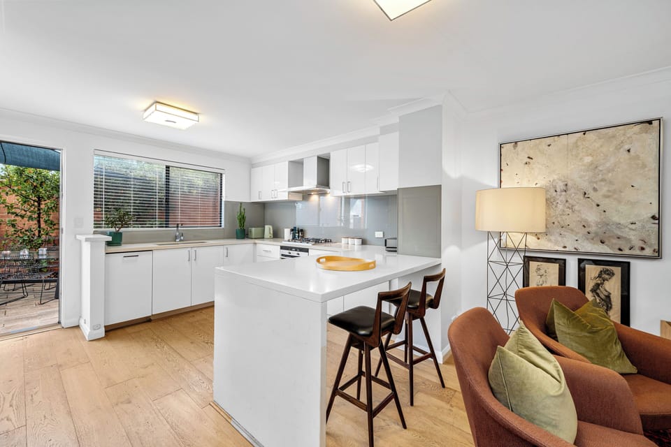 Entertain with ease! Bright, open-concept kitchen and living area flows seamlessly to a charming outdoor space.
