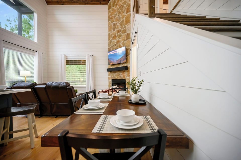 Another angle of the dining space highlighting the open-concept design and natural light.