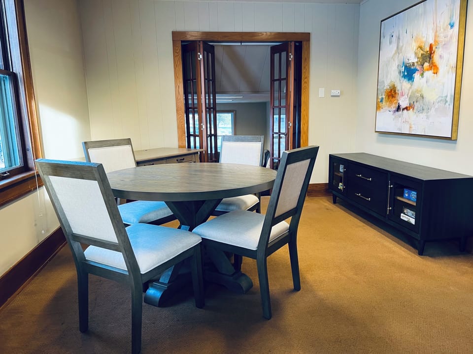 Cozy side room with table for 4 and games for meals, play, or conversation.