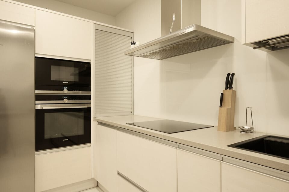 Sleek gourmet kitchen featuring professional-grade built-in appliances and ample counter space.