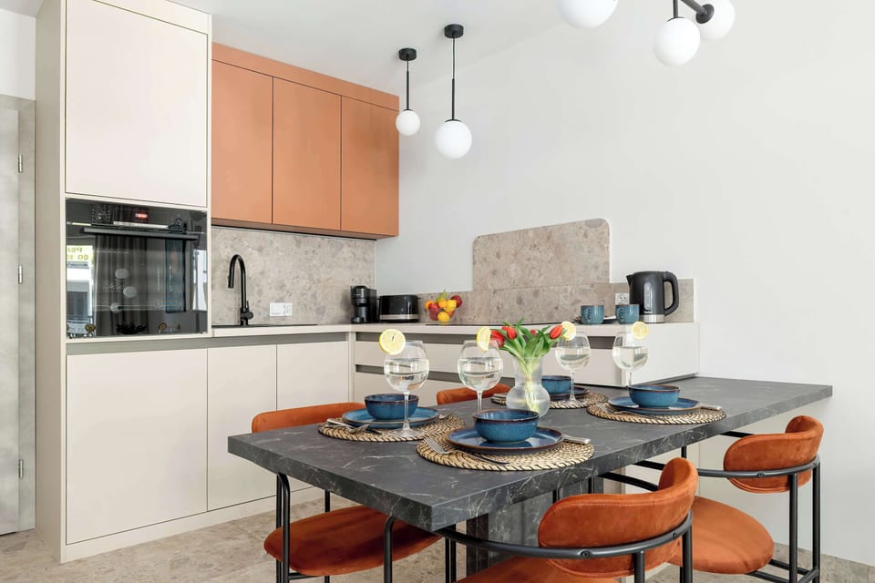 Stylish dining space with a modern table setting and open kitchen background.