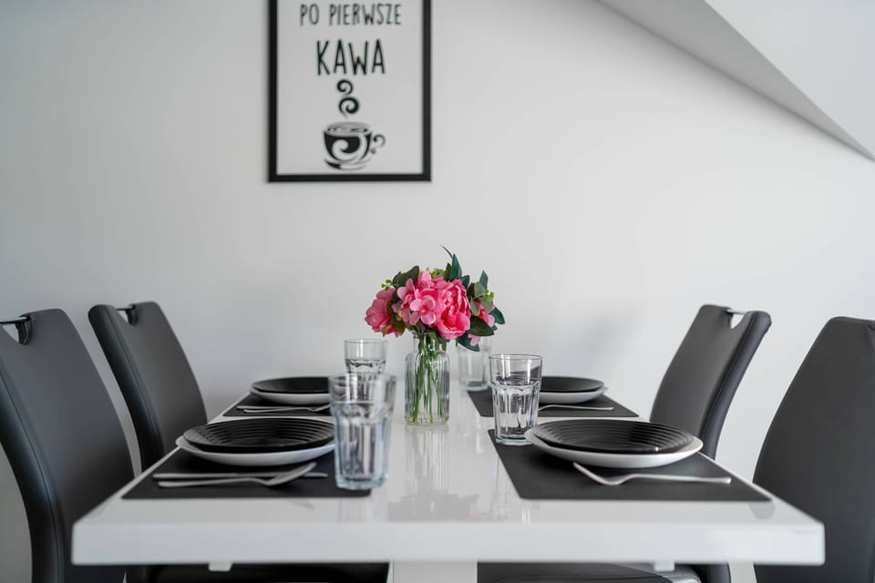 The living area features a sleek table and a flat-screen television.