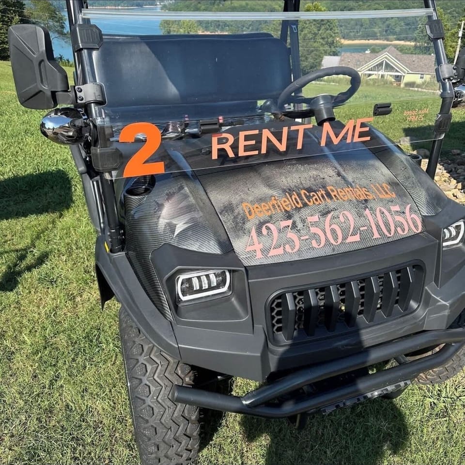 Golf cart with “Rent Me” signage and rental information displayed on the front.