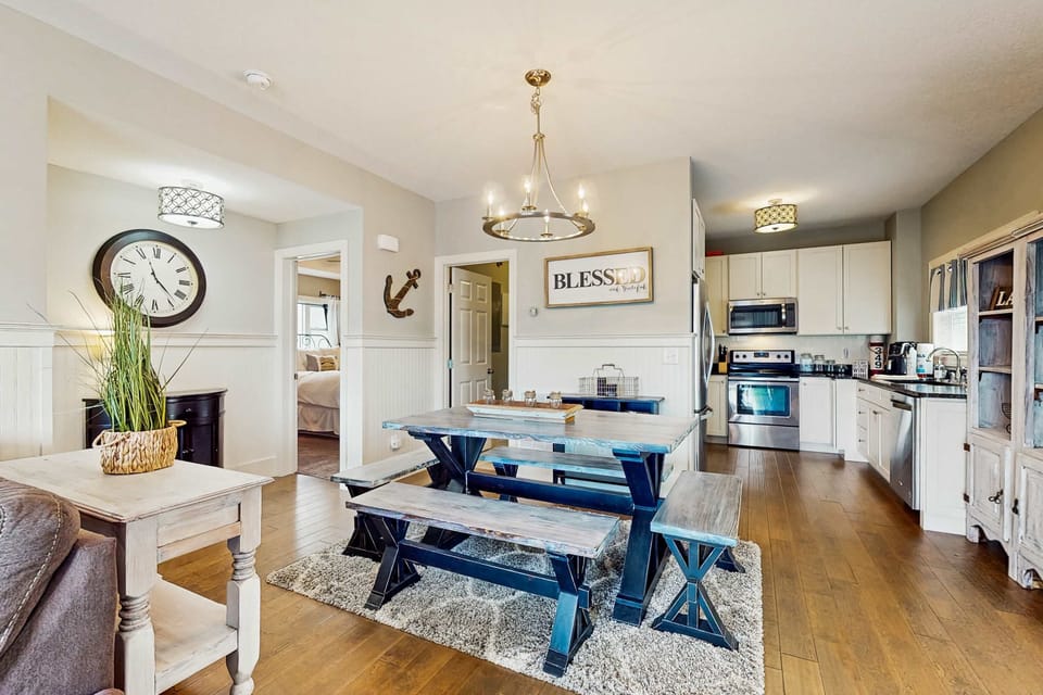 Dining space with chandelier lighting and direct view into the kitchen area.
