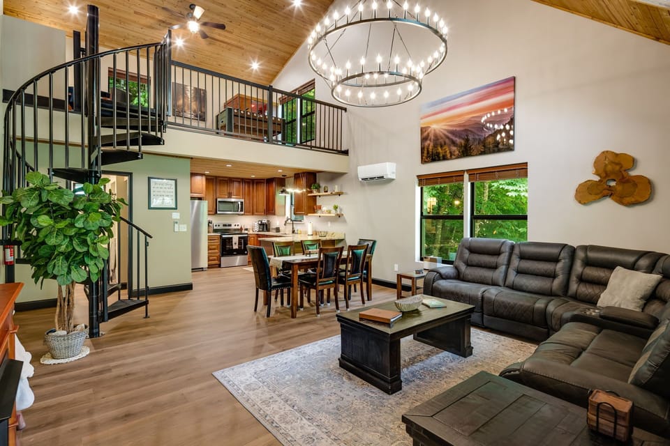 Open concept living room with comfortable seating and cabin charm