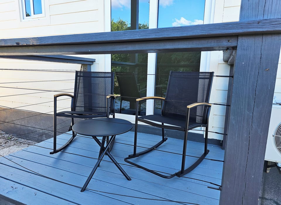 Small out sitting are with two chairs and small table.