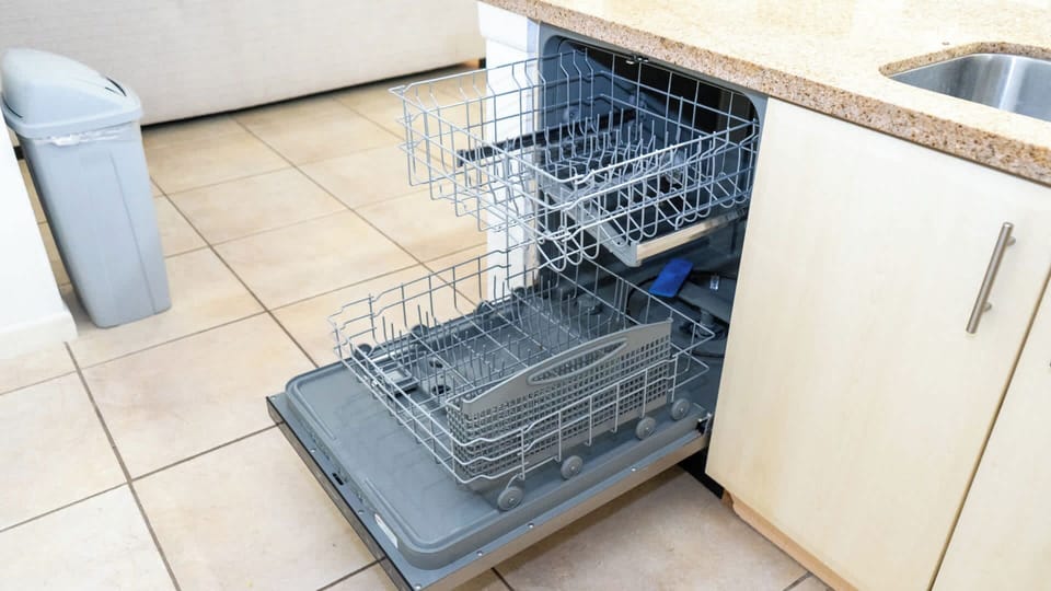 Spotless Dishwasher Ready
Full-size dishwasher loaded with racks awaits sandy beach gear and sandy dishes. Tucked beside cabinets and near sink—clean up quick after sunset dinners, keep the vacation vibes spotless!