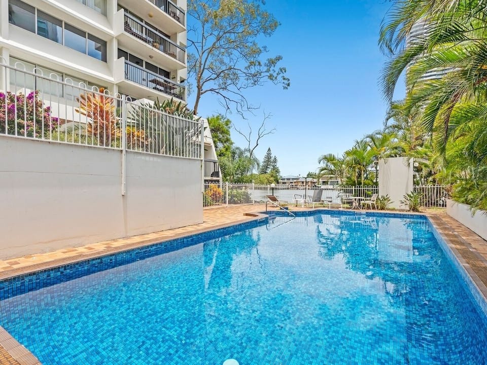 Large north-east pool with sunny lounging space in a peaceful riverside setting.