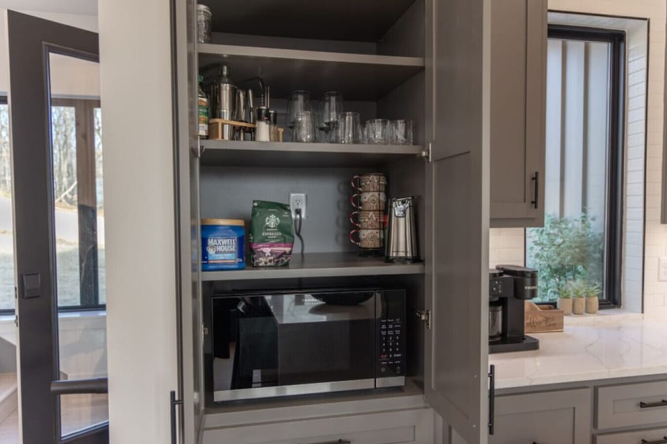 Practical kitchen amenities include a built-in microwave and ample storage for your vacation groceries.