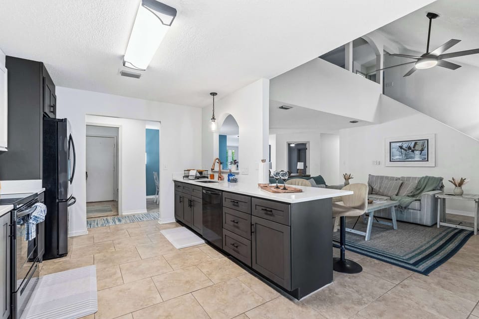 Open-concept living space w/ kitchen island seating & seamless flow for gathering