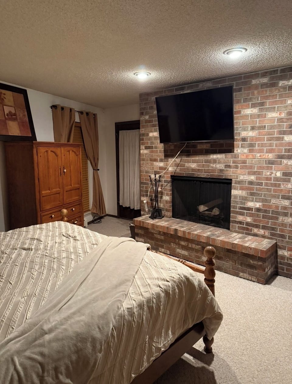Master with new smart TV over fireplace!
