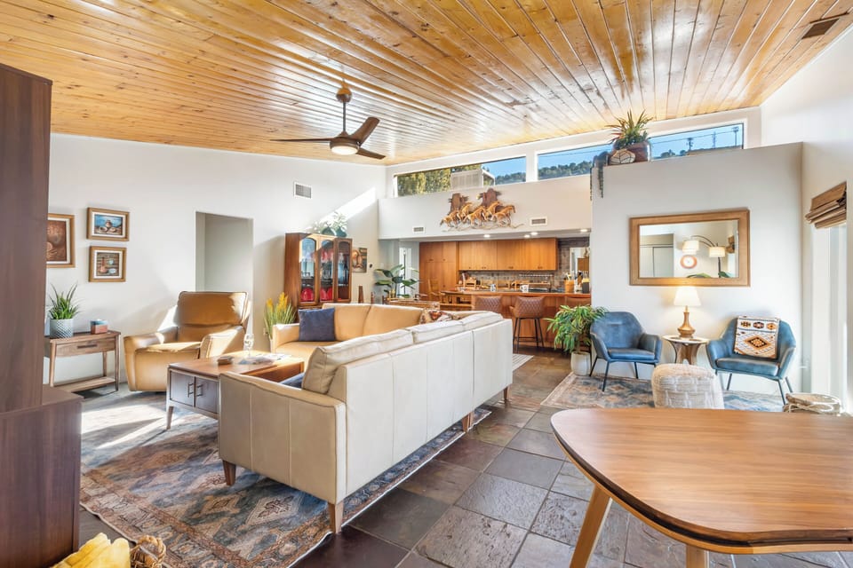 Living room-hardwood floors, and sliding glass doors that open onto the covered patio, seamlessly blending indoor and outdoor spaces.