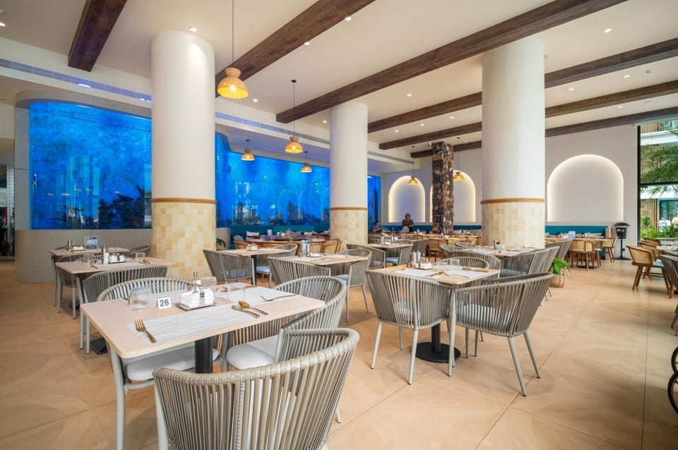 Elegant restaurant with modern decor, spacious seating, and ambient lighting, offering a comfortable dining setting.