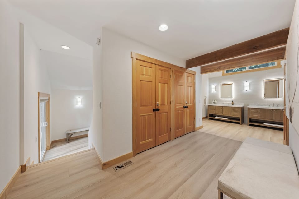 Spacious light-filled hallway leading from the primary's ensuite.