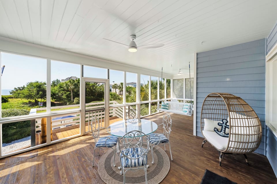 Coastal breezes and morning coffee—your favorite spot is waiting on the screened porch.