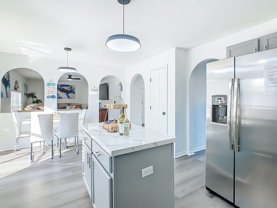 Full kitchen view w/ stainless appliances & generous counter space.