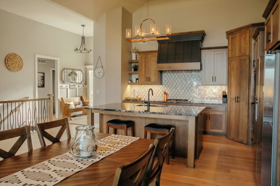 A view of the welcoming entryway and gorgeous kitchen from the dining area.