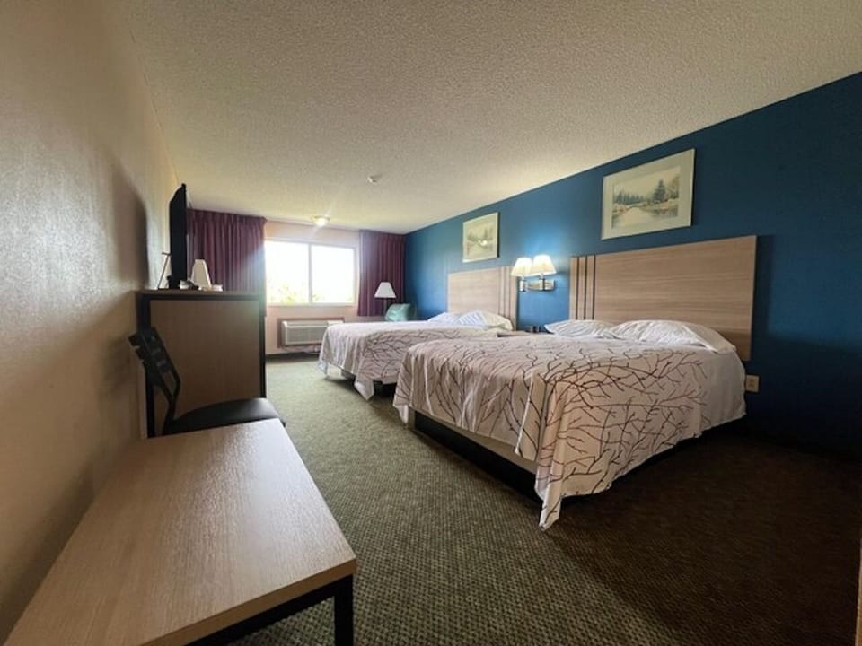Wake up to natural light in a spacious double-queen room.