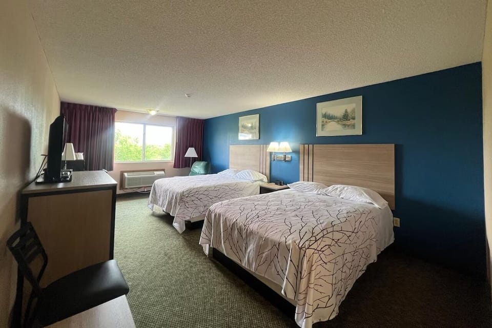 Stretch out in a bright double-queen room with window view.