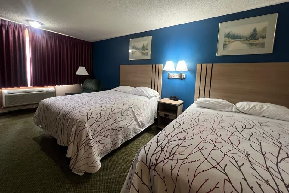 Drift off comfortably on crisp linens under warm bedside lights.