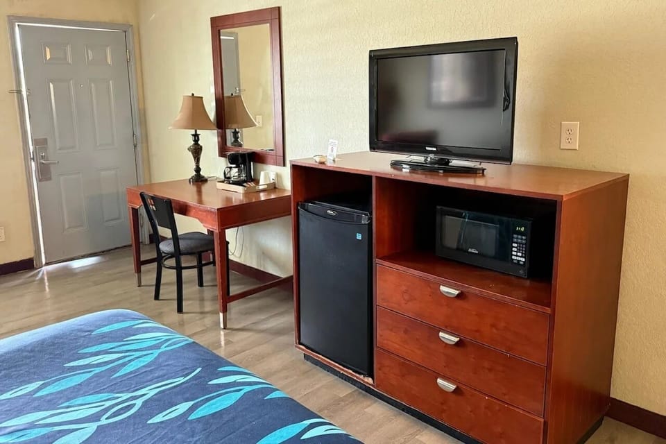 Settle in with TV, mini-fridge, and an easy workspace.