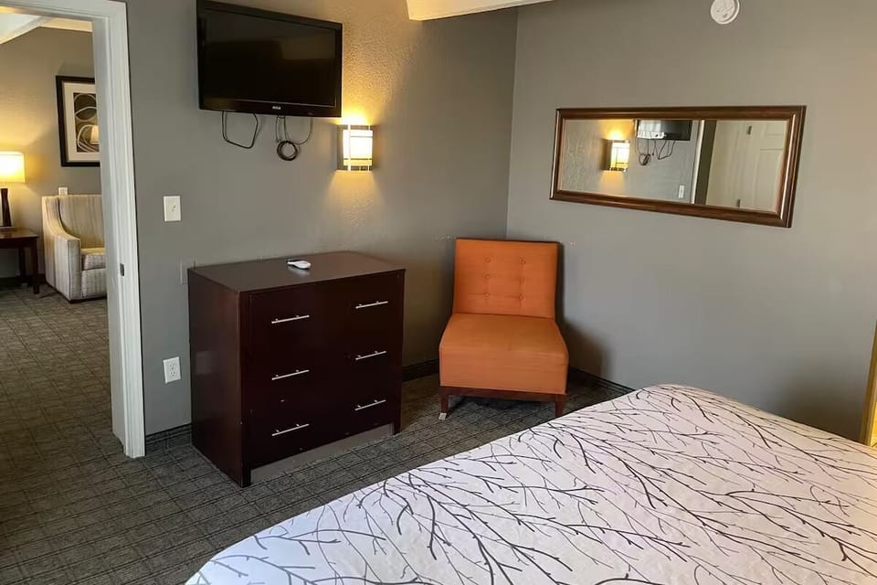 Unwind after adventures with TV, dresser storage, and cozy chair.