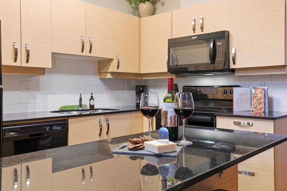 A spacious kitchen equipped with all the essentials, along with a bar stool