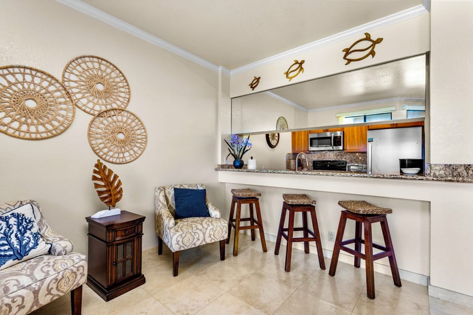 Settle into your coastal retreat where the living area flows into a stylish breakfast bar—perfect for morning coffee or casual meals while you plan your island adventures.