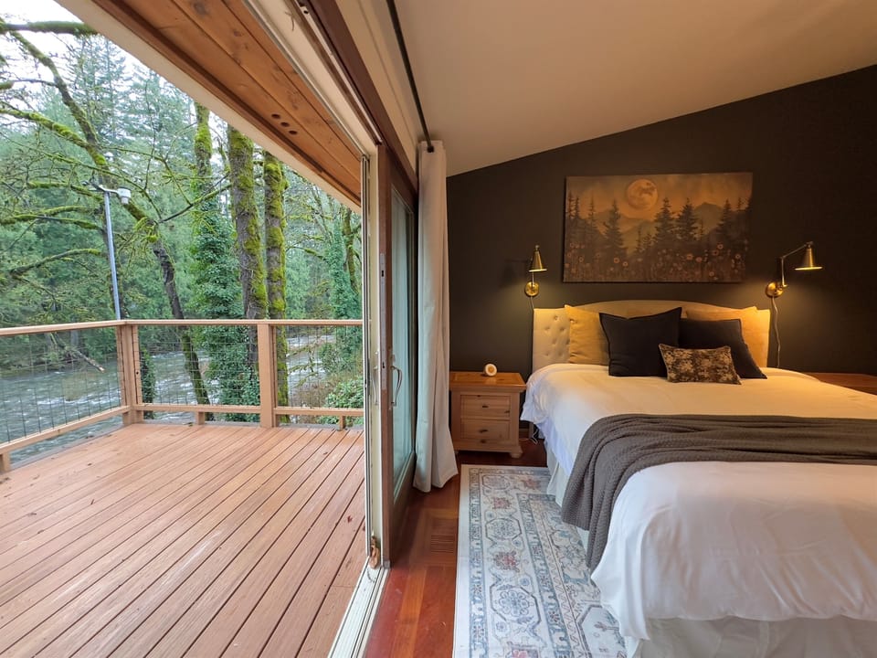 The primary suite on the main level is perched above the Salmon River. Snuggle on the cozy king bed or walk out to the large sundeck overlooking the river. Crack the large sliding glass door open & fall asleep to the sounds of the river or the 50" Roku TV 