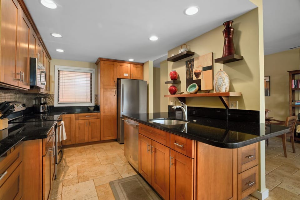 Your gourmet kitchen features rich wood cabinets, granite countertops, and stainless appliances—perfect for creating memorable meals during your stay.