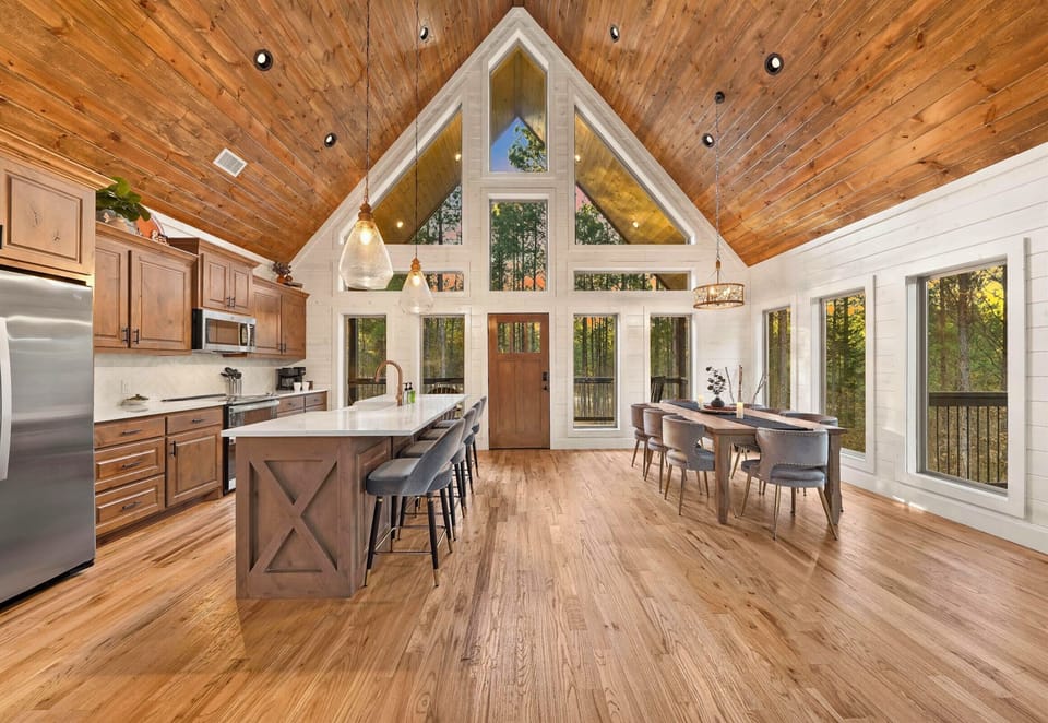 Bright kitchen and dining area with vaulted ceilings and natural light.