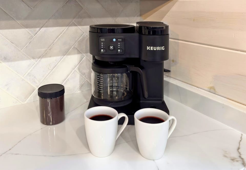 Coffee bar with maker, mugs, and essentials for morning brews.