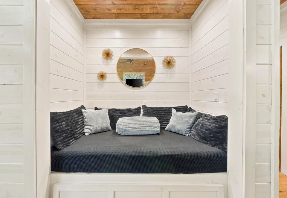 Bedroom with minimalist design and cozy bedding.