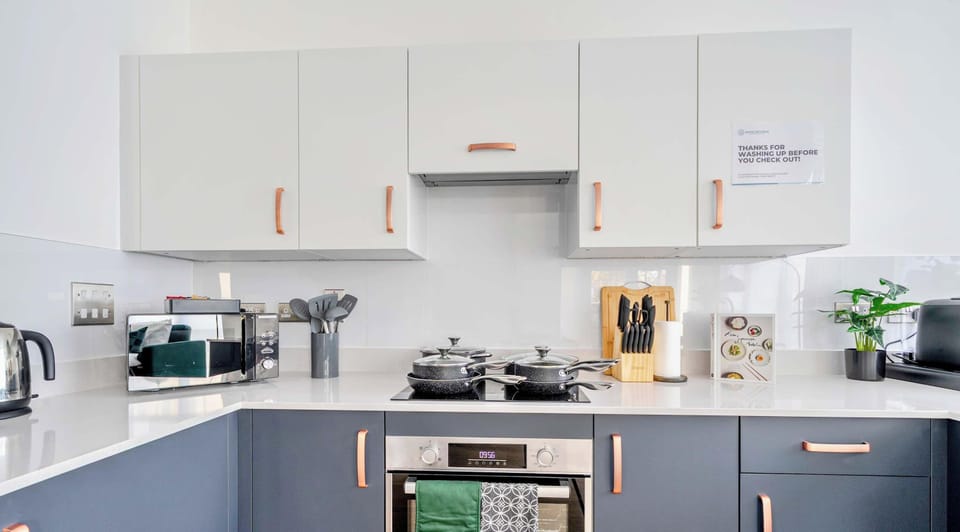 Modern kitchen with dishwasher and full appliances