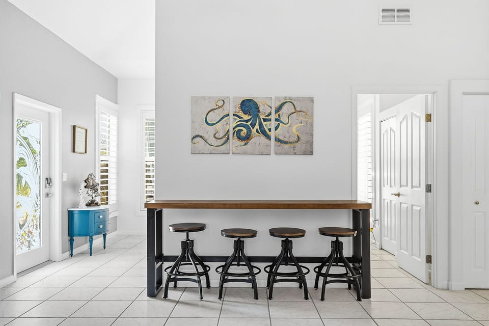 Gather around this stylish high-top dining table where you can enjoy casual meals and conversations in the bright, airy space with coastal-inspired décor.