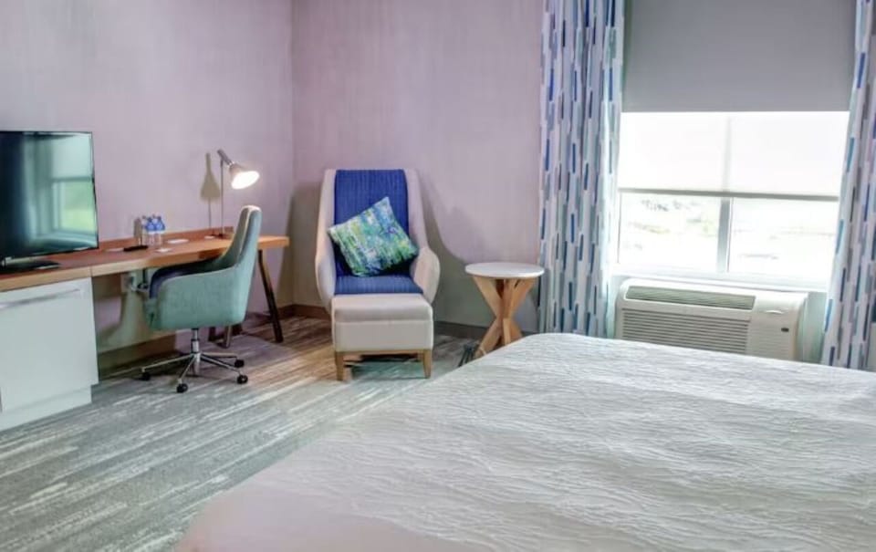 Recharge by the window in a cozy chair and workspace.