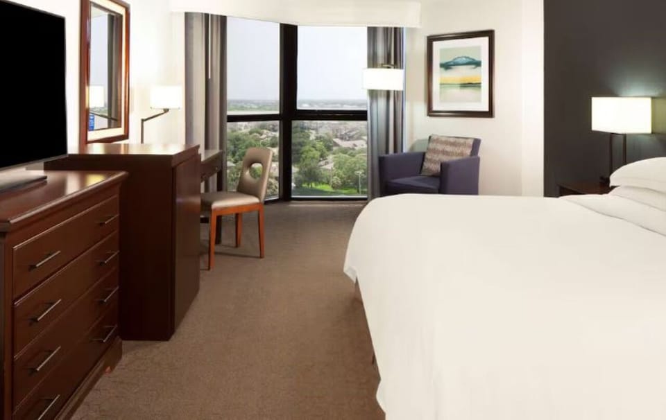Wake up refreshed with plush bedding and sweeping city views.