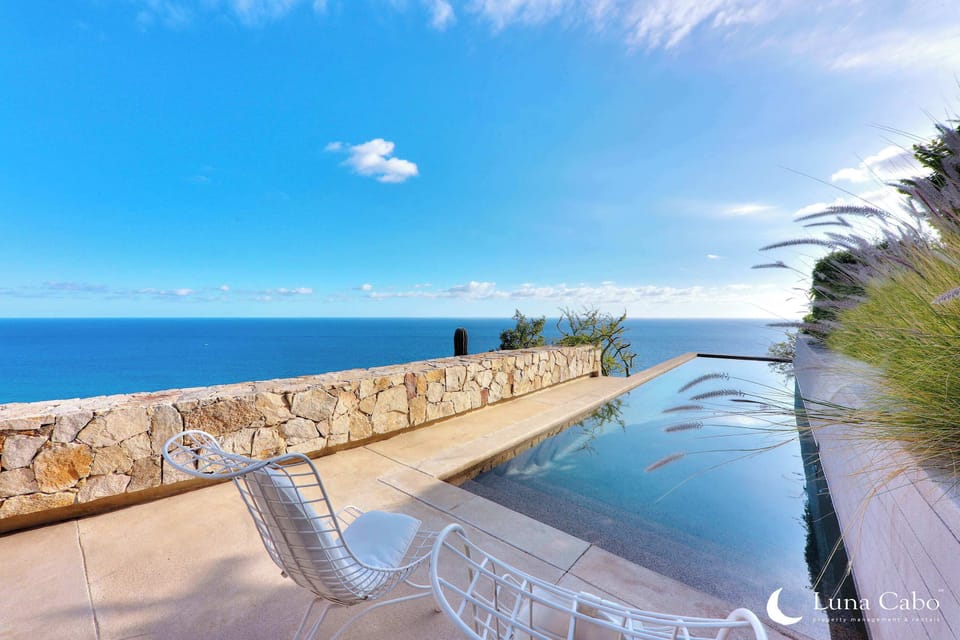 Lounge poolside with stunning coastal views, designed for ultimate relaxation.
